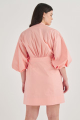 Profile view of model wearing the Oroton Short Utility Dress in Primrose and 100% Cotton for Women