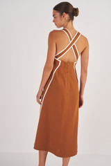 Profile view of model wearing the Oroton Contrast Bind Apron Dress in Brandy and 100% Linen for Women