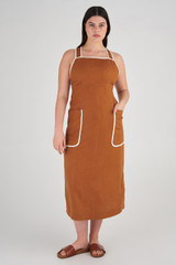 Profile view of model wearing the Oroton Contrast Bind Apron Dress in Brandy and 100% Linen for Women