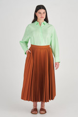 Profile view of model wearing the Oroton Pleat Skirt in Brandy and 65% Polyester, 35% Cotton for Women