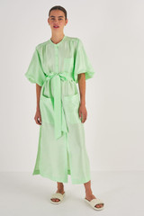 Profile view of model wearing the Oroton Column Shirt Dress in Pear and 100% Silk for Women