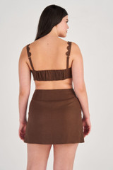 Profile view of model wearing the Oroton Scallop Wrap Skirt in Dark Chocolate and 100% Linen for Women