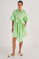 Profile view of model wearing the Oroton Long Sleeve Gathered Shirt Dress in Pear and 100% Cotton for Women