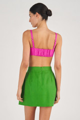 Profile view of model wearing the Oroton Bow Detail Skirt in Garden and 100% Linen for Women