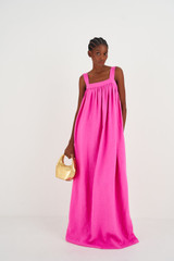 Profile view of model wearing the Oroton Bow Detail Sundress in Fuchsia and 100% Linen for Women