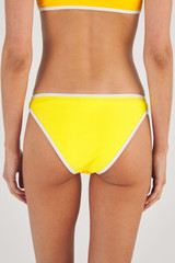 Profile view of model wearing the Oroton Contrast Separate Bottom in Vibrant Yellow and 78% Recycled Nylon/ 22 % Lycra for Women