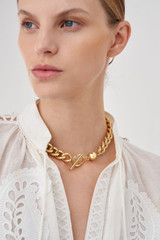 Profile view of model wearing the Oroton Savannah Necklace in Gold and Brass Base Metal With 12CT Gold Plating for Women