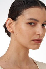 Profile view of model wearing the Oroton Mayla Studs in Worn Gold and Brass Base With 18CT Gold Plating for Women