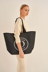 Profile view of model wearing the Oroton Kaia Shopper Tote in Black and Coated canvas material for Women . IP:5