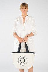 Profile view of model wearing the Oroton Kaia Mini Shopper Tote in Natural/Black and Coated Canvas for Women . IP:3