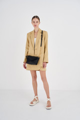 Profile view of model wearing the Oroton Lilly Zip Top Crossbody in Black and Pebble leather for Women