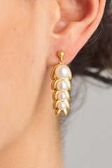 Profile view of model wearing the Oroton Lexie Drop Earrings in Worn Gold/Pearl and Brass Base With 18CT Gold Plating/ Fresh Water Pearl for Women