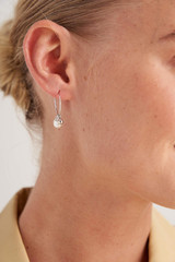 Profile view of model wearing the Oroton Minnie Hoops in Silver and Brass Base With Rhodium Plating for Women