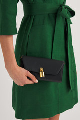 Profile view of model wearing the Oroton Tate Crossbody in Black and Pebble Leather for Women