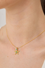Profile view of model wearing the Oroton Starfish Necklace And Stud Set in Worn Gold/Turquoise and Brass base metal with precious metal plating for Women