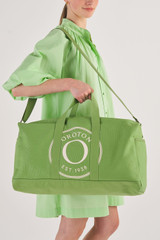 Profile view of model wearing the Oroton Kane Weekender in Watercress and Recycled Canvas for Women
