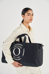 Profile view of model wearing the Accessories Kane Weekender in Black and Recycled Canvas for Women