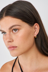 Profile view of model wearing the Oroton Raelyn Huggies in Gold and Brass for Women . IP:2