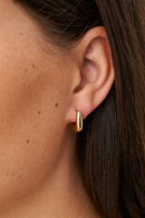 Profile view of model wearing the Oroton Raelyn Huggies in Gold and Brass for Women . IP:3
