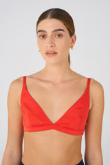 Profile view of model wearing the Oroton Silk Bralette in Poppy and 92% silk, 8% Spandex for Women