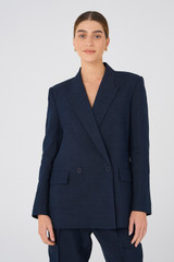 Profile view of model wearing the Oroton Double Breasted Blazer in North Sea and 58% Viscose, 42% Linen for Women