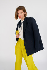 Profile view of model wearing the Oroton Double Breasted Blazer in North Sea and 58% Viscose, 42% Linen for Women