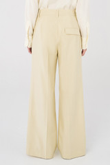 Profile view of model wearing the Oroton Flat Front Pant in Almond and 58% Viscose, 42% Cotton for Women