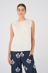 Profile view of model wearing the Oroton Silk Shell Top in Vanilla Bean and 92% silk, 8% Spandex for Women