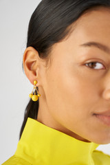 Profile view of model wearing the Oroton Bowman Small Cluster Earrings in Worn Gold/Sun and Brass base metal for Women