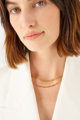 Profile view of model wearing the Oroton Fife Necklace in 18K Gold and 100% recycled sterling silver for Women .