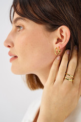 Profile view of model wearing the Oroton Fife Hoops in 18K Gold and 100% recycled sterling silver for Women .