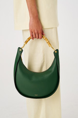Profile view of model wearing the Oroton Quinn Hobo in Dark Treehouse and Smooth leather for Women
