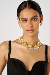 Profile view of model wearing the Oroton Conch Large Earrings in Worn Gold/Clear and Brass for Women