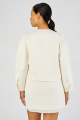 Profile view of model wearing the Oroton Crop Jacket in Cream and 58% Viscose, 42% Linen for Women