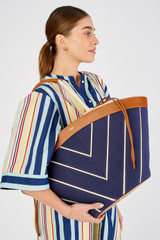Profile view of model wearing the Accessories Callaway Tote in Fisherman Blue/Amber and Canvas for Women