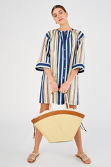 Profile view of model wearing the Oroton Callaway Straw Tote in Natural/Amber and Woven straw with leather trims for Women