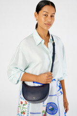 Profile view of model wearing the Oroton Florence Small Shoulder Bag in North Sea and Premium smooth leather for Women . IP:5