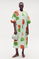 Profile view of model wearing the Oroton Posie Garden Column Dress in Sea Spray and 100% silk for Women