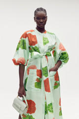 Profile view of model wearing the Oroton Posie Garden Column Dress in Sea Spray and 100% silk for Women