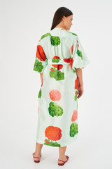 Profile view of model wearing the Oroton Posie Garden Column Dress in Sea Spray and 100% silk for Women