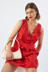 Profile view of model wearing the Oroton Lace Shift Dress in Poppy and 100% polyester for Women