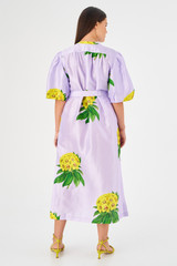 Profile view of model wearing the Apparel Golden Column Posie Dress in Lilac and 100% silk for 