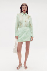 Profile view of model wearing the Oroton Lace Mini Skirt in Sea Spray and 100% polyester for Women . IP:2