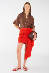 Profile view of model wearing the Oroton Poplin Short Sarong Skirt in Poppy and 100% cotton for Women
