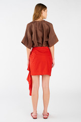 Profile view of model wearing the Oroton Poplin Short Sarong Skirt in Poppy and 100% cotton for Women