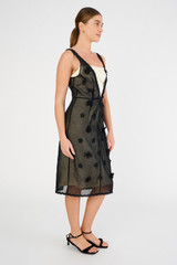 Profile view of model wearing the Oroton Mini 3D Flower Overlay Shift Dress in Black/Cream and Underlay: 80% acetate, 20% polyester/overlay:100% cotton for Women