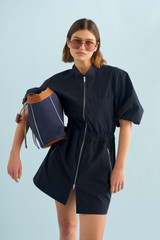 Profile view of model wearing the Oroton Zip Utility Dress in North Sea and 100% cotton for Women