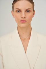 Profile view of model wearing the Oroton Leighton Necklace in Gold and Brass for Women