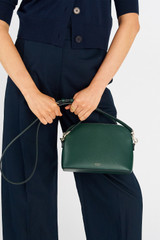 Profile view of model wearing the Oroton Inez Slim Crossbody in Juniper and Saffiano Leather for Women