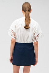 Profile view of model wearing the Oroton Lace Trim Blouse Top in White and 100% cotton for Women